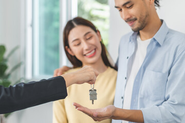 Happy asian couple client, tenant buy home ,apartment. Realtor holding key chain giving new landlord after sign signature contract rental purchase, bank approve mortgage, loan. Property of financial.