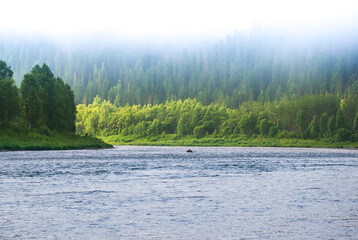 Landscapes of Siberia. Early morning on the Kiya river. Fog descends on the river over the taiga. Kemerovo region.