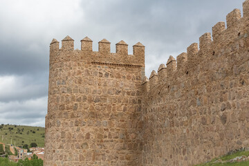 Detailed view of Ávila city Walls and fortress tower, blue sky as background