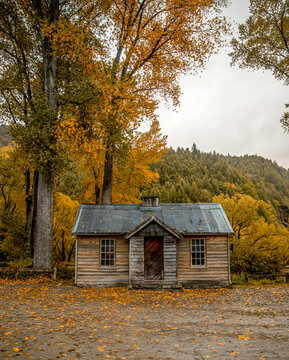 Travel lifestyle view of an abandoned wooden cabin in Arrowtown, historic gold mining town in the Otago region of the South Island of New Zealand.