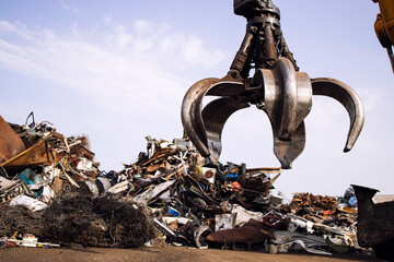 Industrial scrap metal recycling and crane lifting parts in junk yard. - obrazy, fototapety, plakaty