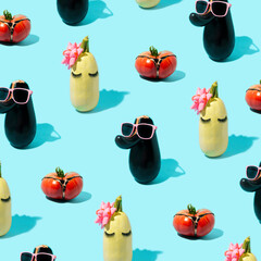 Red tomato pattern with panties, green zucchini with eyelashes and pink bow and eggplant with sunglasses. Vegetables. Minimal aesthetics on a blue background.
