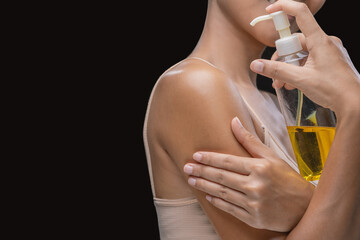 A woman is applying olive oil to her skin.