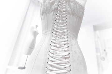Preparation of bridal corset for weddings.