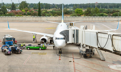 Preparing a passenger plane for loading luggage before departure
