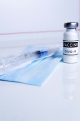 Vertical photography. Coronavirus vaccination medical concept. Vaccine dose on a white background with place for your text