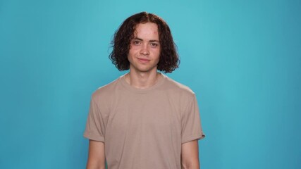 Portrait of Handsome Guy says Believe in yourself for people who are deaf and hard of hearing. Motivational phrase on American Sign Language ASL 