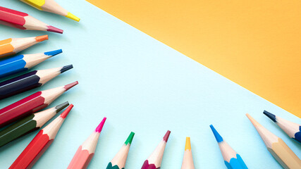 Pencils on empty sheet, blue and Orange tones