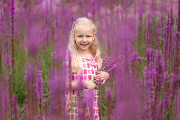 Little girl in a field with wildflowers