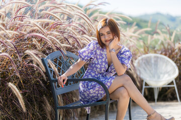 A smart woman short hair in soft dress  on cafe hight hill, she is happy and like on trip for...