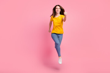 Fototapeta na wymiar Full size photo of cool brunette millennial lady run wear pink sweater jeans sneakers isolated on pink background