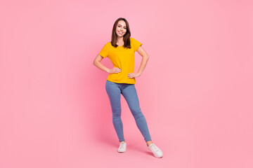 Fototapeta na wymiar Full length photo of brunette hair millennial lady stand wear jeans t-shirt isolated on pink color background