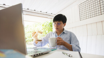Asian people 30s drinking coffee and relaxing after looking  new trading  platforms stock tickers...