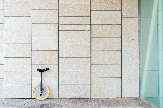 Unicycle parked near modern building