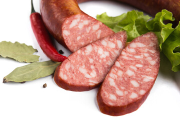 baked smoked sausage with lard on a white plate