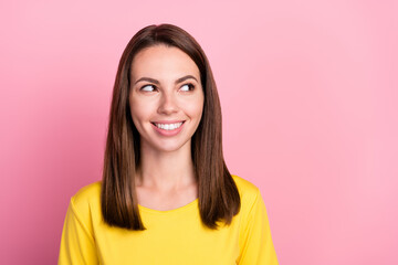 Fototapeta premium Photo of sweet adorable young lady wear yellow t-shirt smiling looking empty space isolated pink color background
