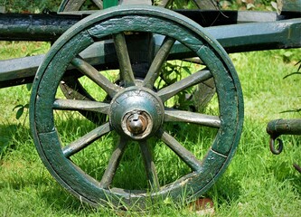 Fototapeta na wymiar Old antique metal wheel in nature