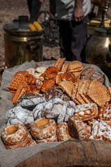 An assortment of artisan bread is available at the farmers ' market. Many different types of bread wrapped in craft paper. Small business concept-baking and cooking