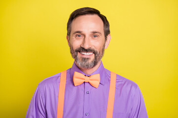 Photo of mature handsome man happy positive smile confident elegant bowtie isolated over yellow color background