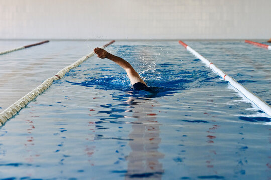 Man swimming in freestyle in pool