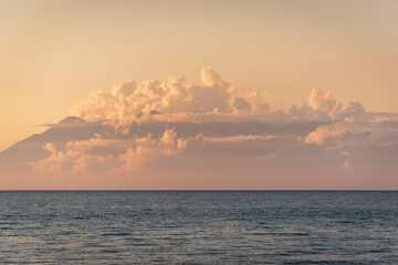 Albania coast surrounded by clouds during sunset seen from Corfu island in Greece