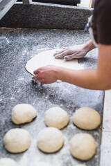 Chef prepares the pizza dough in the restaurant. Baker prepares dough for baking. High quality photo