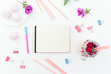 Smoothie with straws, marshmallow, anemones flowers and diary on white background