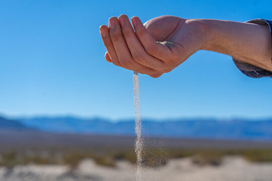 hand with sand running through it