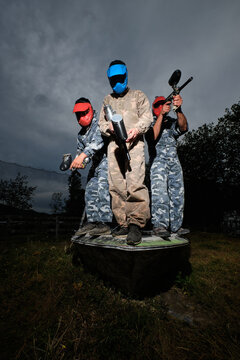 Company of men playing paintball