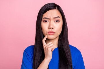 Photo of minded young doubtful woman hold finger chin think idea plan isolated on pink color background