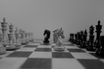 WOODEN CHESS PIECES AND BOARD IN MONOCHROMATIC THEME