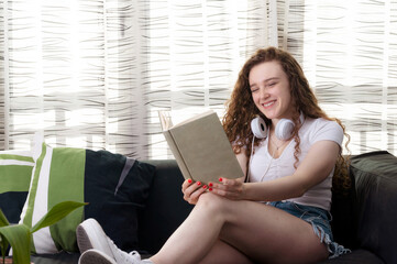 Young Caucasian woman happy to read a book