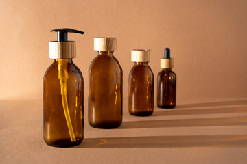 Eco friendly bottles for cosmetics. Glass bottle with a wooden lid with a dispenser and a pipette. Beauty and skin care. Brand packaging, place for text. Bottle products. Minimalism concept.