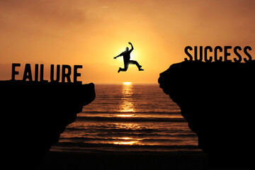 Failure and Success concept with silhouette of a person jumping over the cliff at sunset beach 