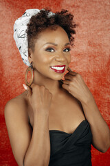 Pretty smiling young black latin American girl in black shirt and white turban head scarf
