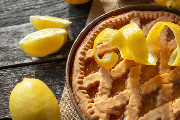 lemon tart and fresh citrus, baking cake dessert on an old table. 