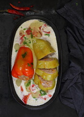 Pepper stuffed with meat and rice on a black background