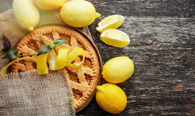 lemon tart and fresh citrus, baking cake dessert on an old table. 