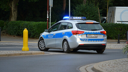 Polska policja drogowa podczas pracy na drodze w mieście. Pojazdy policyjne. 
