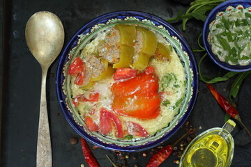 Pepper stuffed with meat and rice on a black background