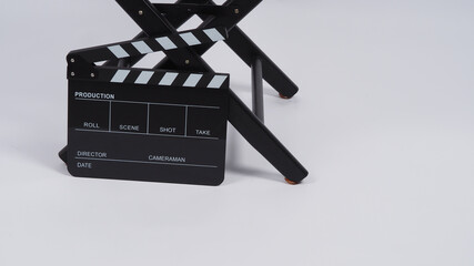 Fototapeta na wymiar Black Clapper board or movie slate with director chair use in video production or movie and cinema industry. It's put on white background.