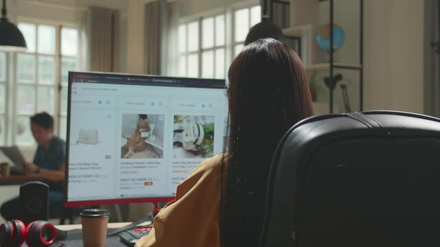 Asian Business Woman Using Desktop Computer Shopping Online At Office

