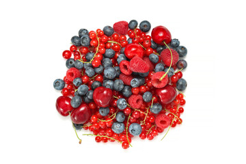 Various berries isolated top view, cherries with blueberries, red currants and raspberries at the white background