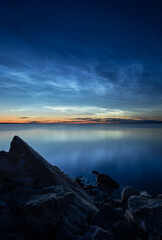 Beautiful noctilucent clouds over lake Vanern in Sweden