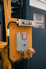 control panel with buttons and switches on the orange wall