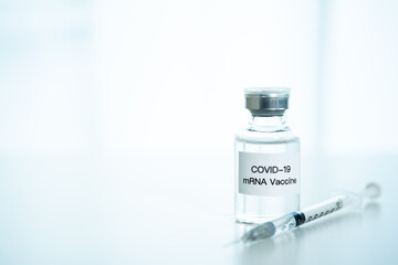 Coronavirus 2019 or SARS 2019-nCoV cure vaccine in mRNA technology and medical needle close up. 