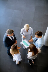 Aerial view at group of business people working together and preparing new project on a meeting in...