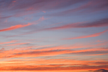 Scenery. Photo of the evening sky. Crimson yellow clouds against a blue sky at sunset before a thunderstorm.
