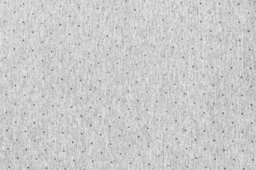Gray fabric made of cotton material with some circles printed with worn texture on a flat surface. Fabric background in light tone.