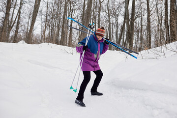 Portrait of a senior skier in a winter forest
